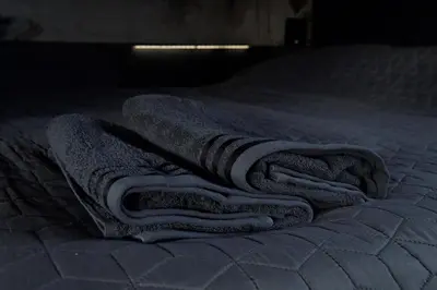 a pile of towels laying on a bed at EUPHRATE HOUSeBOAT in Amsterdam