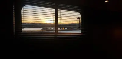 a window with a view of an airport with an airplane at EUPHRATE HOUSeBOAT in Amsterdam