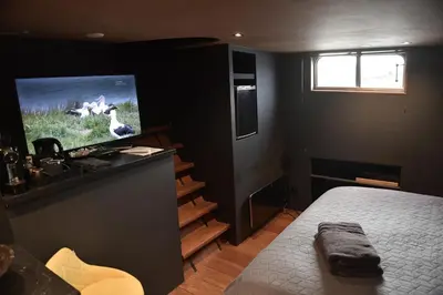 a bedroom with a bed and a flat screen tv at EUPHRATE HOUSeBOAT in Amsterdam