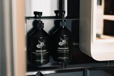 two bottles of wine sitting on a shelf at Max Brown Hotel Canal District, part of Sircle Collection in Amsterdam