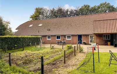 a house with a fence in front of it at Lovely Home In Putten With Kitchen in Putten