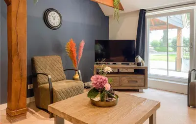 a living room with a table and a tv at Lovely Home In Putten With Kitchen in Putten