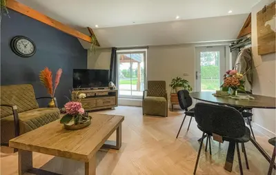 a living room with a table and a tv at Lovely Home In Putten With Kitchen in Putten