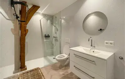 a bathroom with a toilet and a shower with a mirror at Lovely Home In Putten With Kitchen in Putten