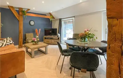 a living room with a table and chairs at Lovely Home In Putten With Kitchen in Putten