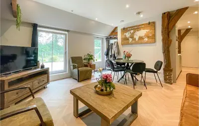 a living room with a television and a table at Lovely Home In Putten With Kitchen in Putten