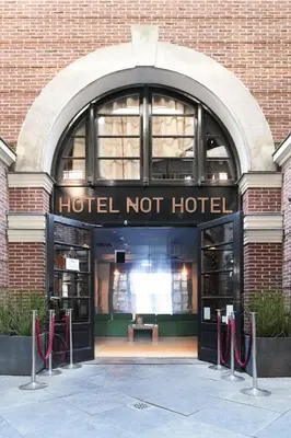 a hotel not hotel entrance with a brick building at Hotel Not Hotel Amsterdam in Amsterdam