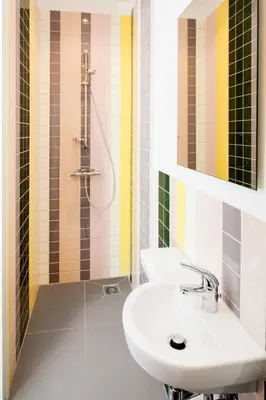 a bathroom with a sink and a shower at Hotel Not Hotel Amsterdam in Amsterdam