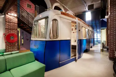 a room with a train on display in a building at Hotel Not Hotel Amsterdam in Amsterdam