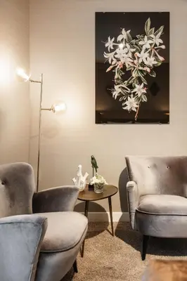 a living room with two chairs and a table and a painting at The Delphi - Amsterdam Townhouse in Amsterdam