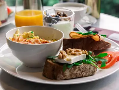 a plate with a bowl of food and a bowl of soup at Maison ELLE Amsterdam in Amsterdam