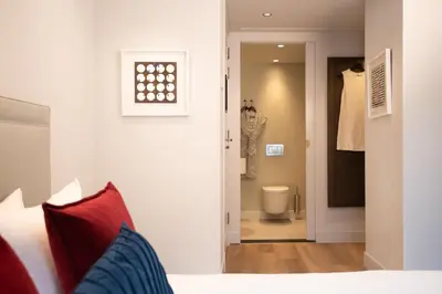 a bedroom with a bed and a bathroom with a toilet at Maison ELLE Amsterdam in Amsterdam