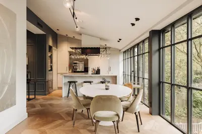 a kitchen and dining room with a table and chairs at Maison ELLE Amsterdam in Amsterdam