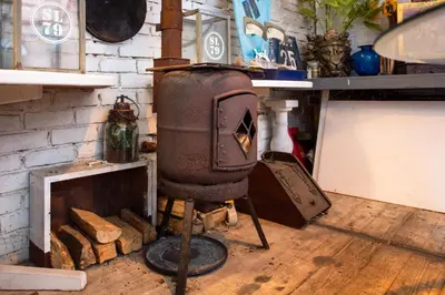 an old stove in a room with a brick wall at Gezellig appartement in de mooie oude binnenstad van Alkmaar in Alkmaar