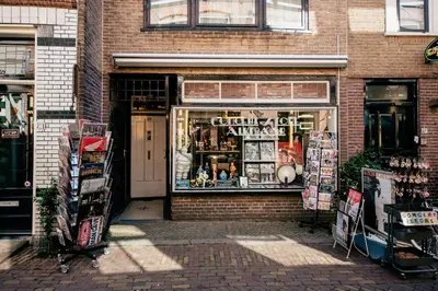 a store front of a brick building with a window at Gezellig appartement in de mooie oude binnenstad van Alkmaar in Alkmaar