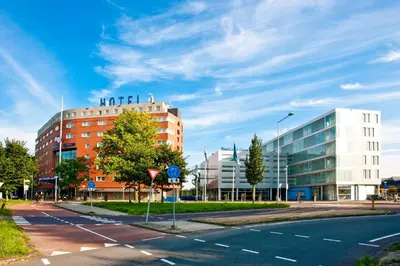 an empty street in a city with a building at WestCord Art Hotel Amsterdam 4 stars in Amsterdam