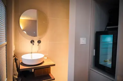 a bathroom with a sink and a mirror at Renovated Parkside Gem - 2 person studio in the Pijp in Amsterdam