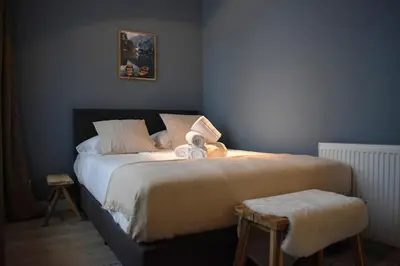 a bedroom with a bed with two stuffed animals on it at Rembrandtplein house A in Amsterdam
