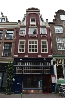 a tall red brick building on a city street at Rembrandtplein house A in Amsterdam
