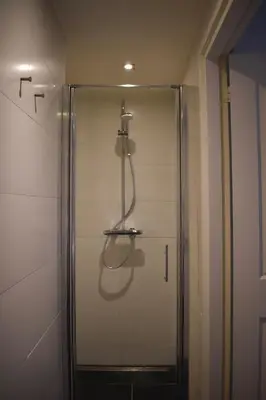 a shower stall with a shower head in a bathroom at Rembrandtplein house A in Amsterdam