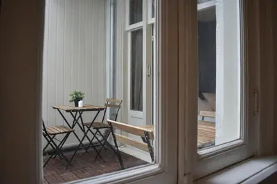 a view of a balcony with a table and chairs at Rembrandtplein house A in Amsterdam