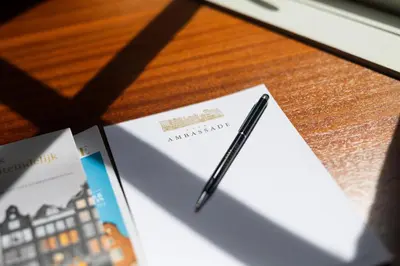 a pen sitting on top of a piece of paper on a table at Ambassade Hotel in Amsterdam