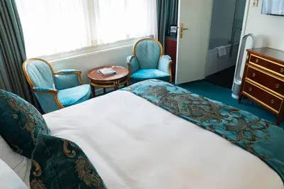 a hotel room with a bed and chairs and a table at Ambassade Hotel in Amsterdam