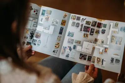 a woman is reading a comic book at Ambassade Hotel in Amsterdam