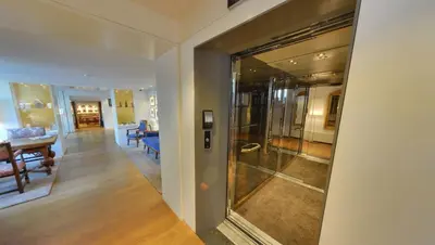 a hallway with a glass door leading to a living room at Ambassade Hotel in Amsterdam