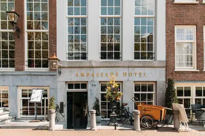 an entrance to an apartment hotel with a bicycle parked outside at Ambassade Hotel in Amsterdam