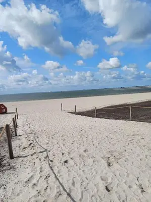 a sandy beach with a fence in the middle at City-beach apartment nearby Amsterdam in Hoorn