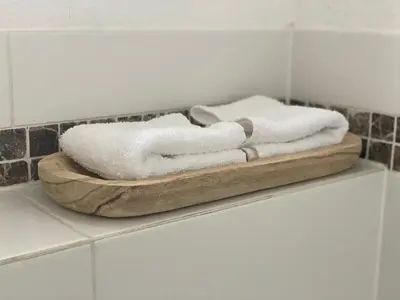 a couple of towels sitting on a shelf in a bathroom at Katwijk Center, 1 min away from the beach! in Katwijk aan Zee