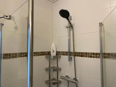 a bathroom with a shower with a shower head at Katwijk Center, 1 min away from the beach! in Katwijk aan Zee