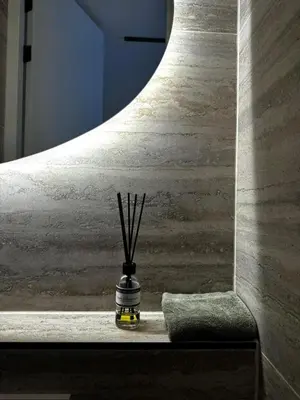 a vase with sticks in it sitting on a ledge at B&B Urban Oasis with Free Parking in Amsterdam