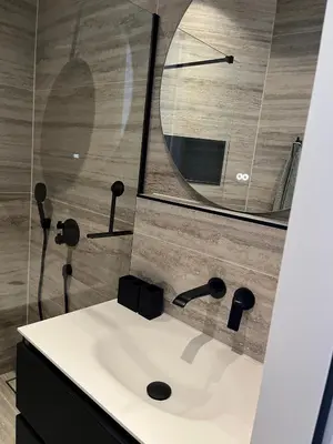 a bathroom with a sink and a mirror at B&B Urban Oasis with Free Parking in Amsterdam