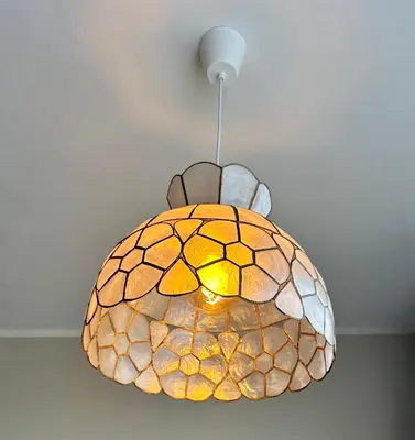 a glass pendant light hanging from a ceiling at Amsterdam Beach Apartment 33, Private Garden in Zandvoort