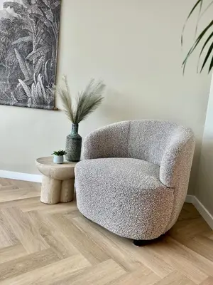 a living room with a chair and a table at Amsterdam Beach Apartment 33, Private Garden in Zandvoort