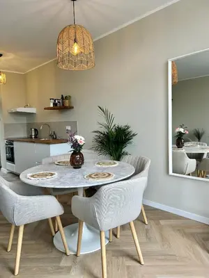 a kitchen and dining room with a table and chairs at Amsterdam Beach Apartment 33, Private Garden in Zandvoort