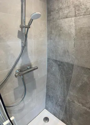 a shower in a bathroom with a glass door at Amsterdam Beach Apartment 17, incl Parking + Garden in Zandvoort
