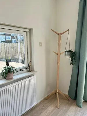 a room with a window and a wooden pole with plants at Amsterdam Beach Apartment 17, incl Parking + Garden in Zandvoort