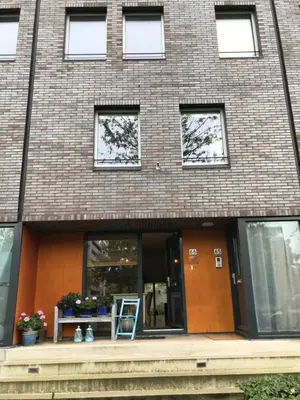 a brick house with a table and a chair in front of it at Great House for Two in Amsterdam in Amsterdam