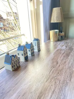 a group of toy houses sitting on a floor next to a window at Great House for Two in Amsterdam in Amsterdam
