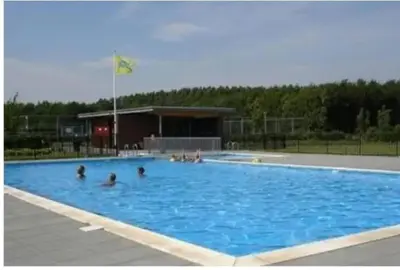 a group of people in a large swimming pool at The Poplar Place, Comfort & Hottub in Zeewolde