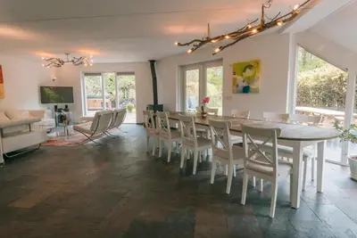 a dining room with a table and chairs at The Poplar Place, Comfort & Hottub in Zeewolde