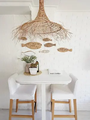 a dining room table with white chairs and a chandelier at ELSK Cottage in Zandvoort