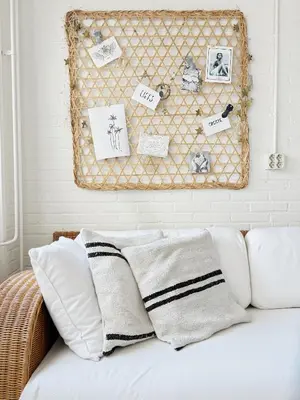 a white couch with pillows and a wall with pictures at ELSK Cottage in Zandvoort