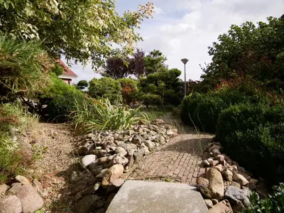 a stone path in a garden with rocks at B&B “Te Warskip bij BlokVis” in Medemblik