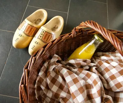 a basket with shoes and a bottle of orange juice at B&B “Te Warskip bij BlokVis” in Medemblik