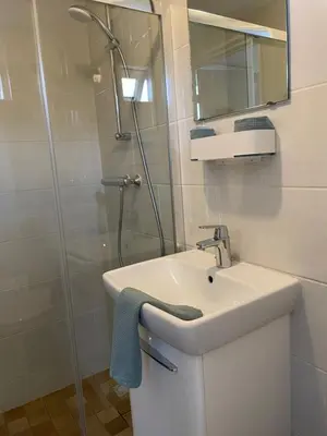 a bathroom with a sink and a shower at Buenaventura in Egmond aan den Hoef