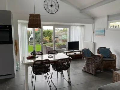 a kitchen and living room with a table and chairs at Buenaventura in Egmond aan den Hoef